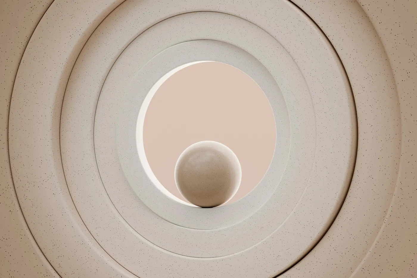 Concentric circles carved into a pale wall with a small sphere at the centre